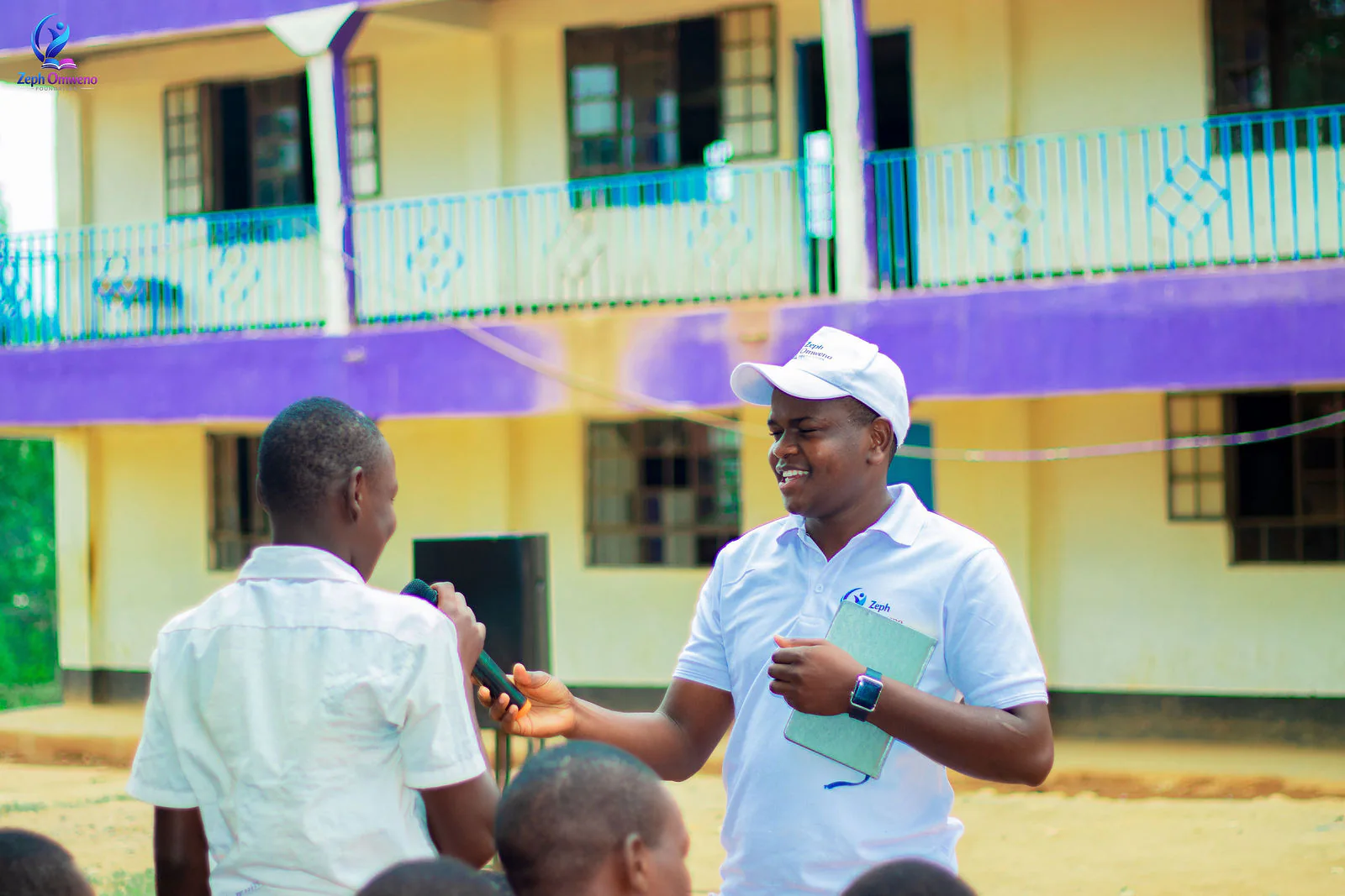 A ZOF mentor handing a student the microphone during a mentorship session