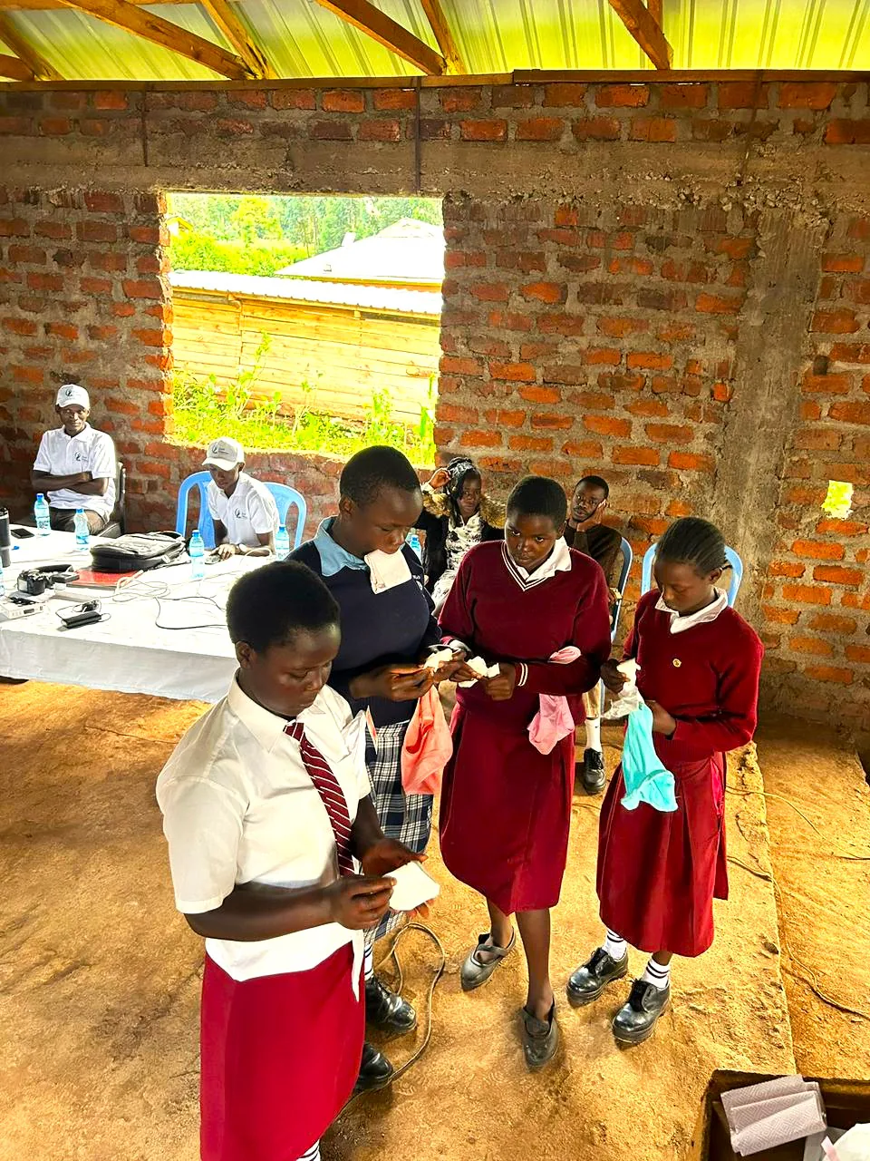 Schoolgirls receiving sanitary towels from the ZOF Hygiene Support Program