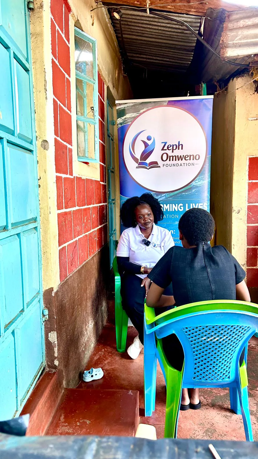 A ZOF counsellor speaking with a young mother during a home visit