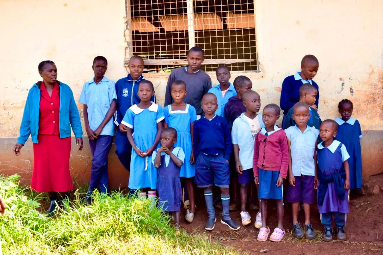 Learners and a parent gathered for the ZOF school uniforms distribution